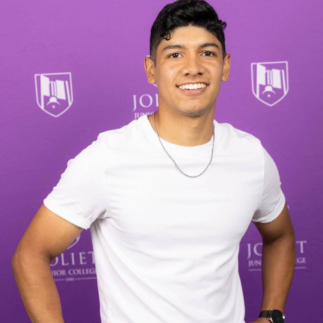 Guy standing in front of purple background